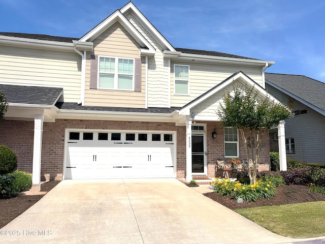view of front facade featuring brick siding, a garage, driveway, and a shingled roof