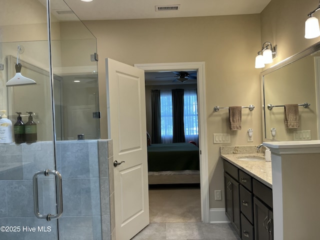 ensuite bathroom featuring vanity, tile patterned floors, a shower stall, and visible vents