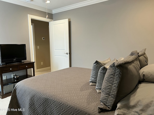 bedroom featuring crown molding and baseboards
