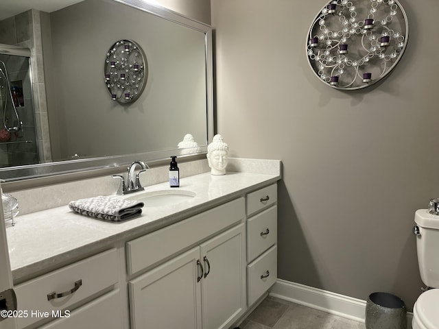 full bathroom with tile patterned flooring, vanity, toilet, baseboards, and tiled shower