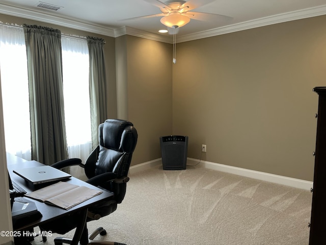 carpeted office featuring crown molding, a ceiling fan, baseboards, and visible vents