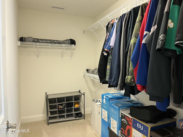 walk in closet featuring visible vents and carpet