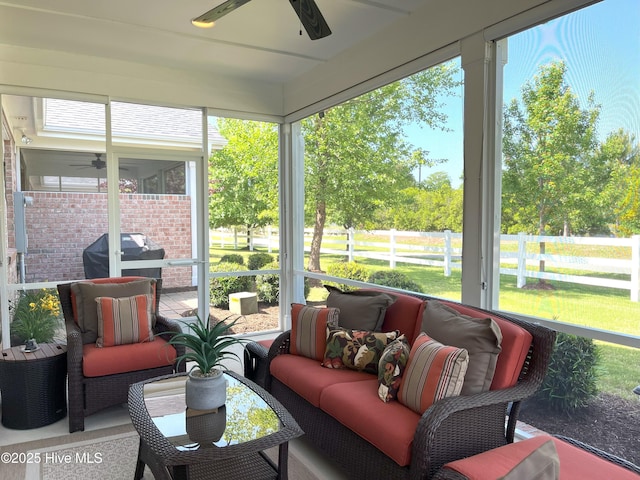 sunroom / solarium featuring a ceiling fan and an outdoor hangout area