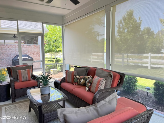 sunroom / solarium featuring a ceiling fan and an outdoor living space