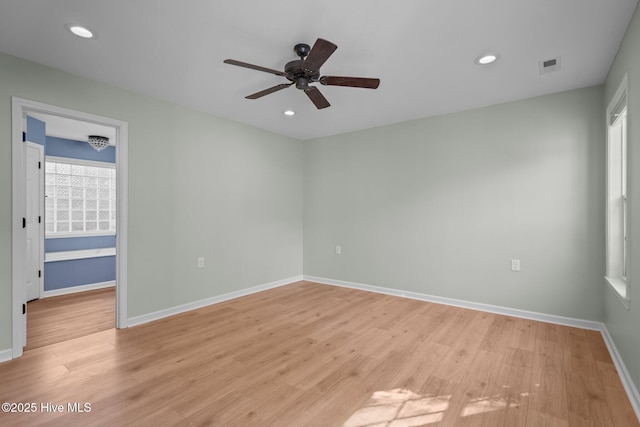 unfurnished bedroom featuring light wood finished floors, visible vents, and baseboards
