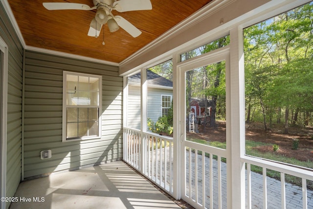 unfurnished sunroom featuring ceiling fan
