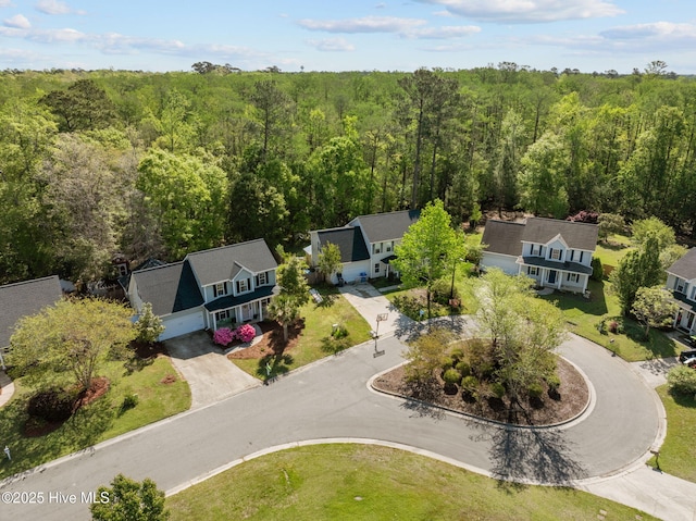 bird's eye view featuring a wooded view
