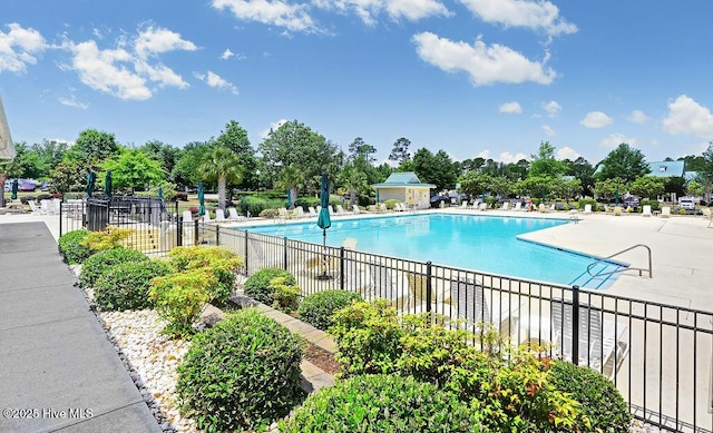 pool featuring a patio and fence