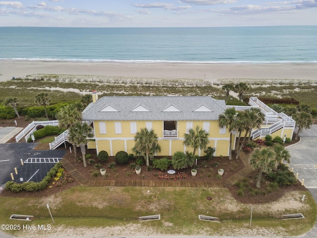bird's eye view featuring a view of the beach and a water view