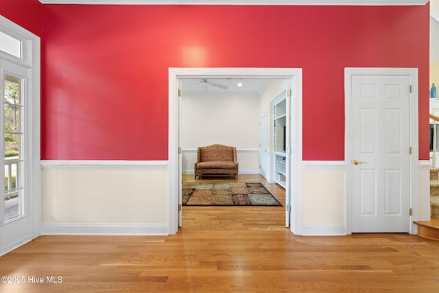 foyer entrance with wood finished floors, ceiling fan, and baseboards