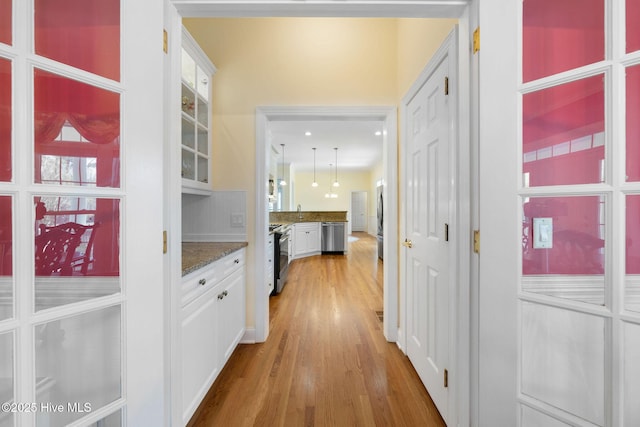 corridor with light wood-style flooring