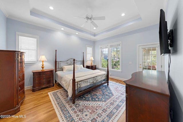 bedroom with access to outside, ornamental molding, a raised ceiling, and light wood-style floors