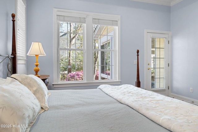 bedroom featuring ornamental molding and multiple windows
