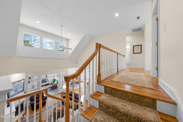 stairs featuring recessed lighting, visible vents, ceiling fan, and wood finished floors