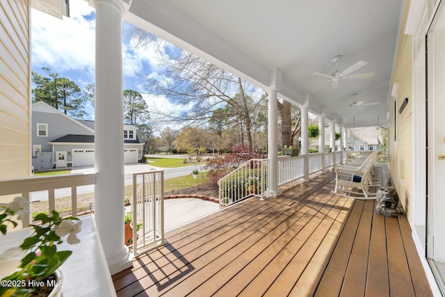 wooden deck with a porch and ceiling fan