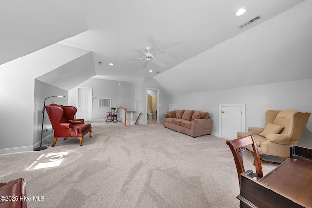 living area featuring lofted ceiling, visible vents, and carpet floors