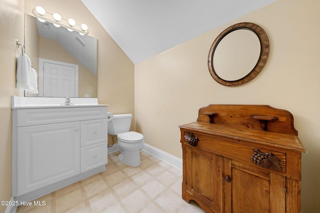 bathroom featuring vanity, visible vents, toilet, lofted ceiling, and baseboards