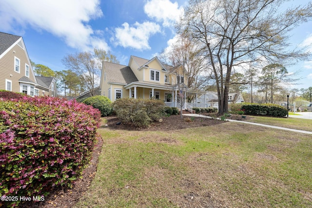 view of front of property with covered porch and a front lawn