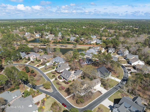 aerial view with a water view, a view of trees, and a residential view