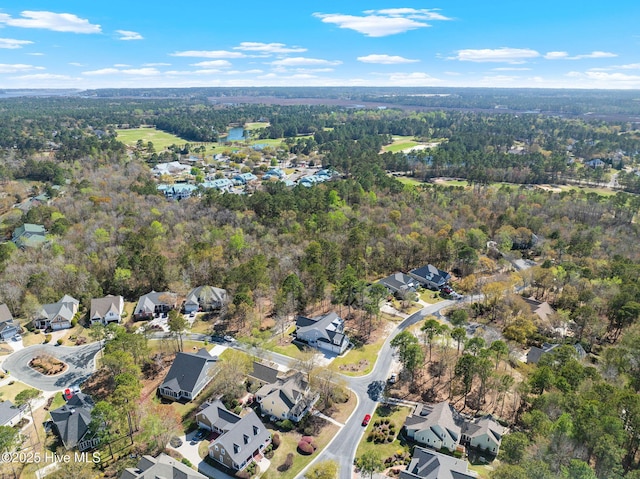 birds eye view of property with a view of trees and a residential view