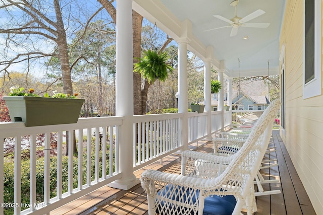 wooden deck with a porch and a ceiling fan