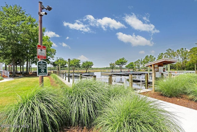 dock area featuring a yard and a water view