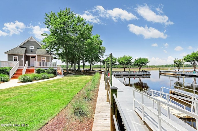dock area with a water view and a lawn