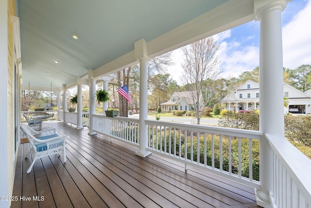 wooden deck with a porch and a residential view