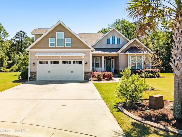 craftsman-style house featuring a porch, stone siding, driveway, and a front yard