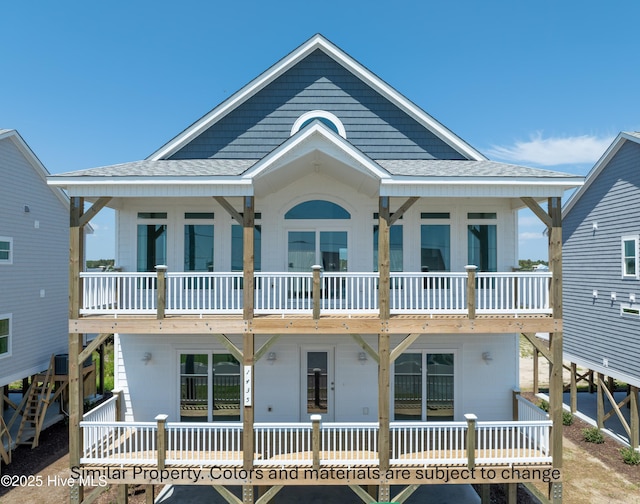rear view of property with roof with shingles