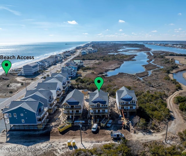 drone / aerial view with a water view and a residential view