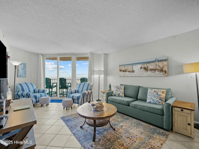 2000 New River Inlet Rd Unit 3513, North Topsail Beach, NC 28460 - living area with light tile patterned floors, a textured ceiling, and expansive windows