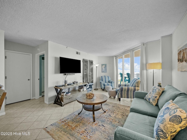 2000 New River Inlet Rd Unit 3513, North Topsail Beach, NC 28460 - living room featuring visible vents, baseboards, light tile patterned flooring, and a textured ceiling