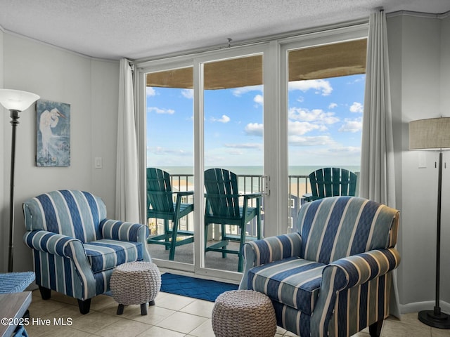 2000 New River Inlet Rd Unit 3513, North Topsail Beach, NC 28460 - sitting room featuring a textured ceiling, tile patterned floors, and a water view