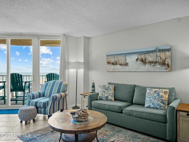 2000 New River Inlet Rd Unit 3513, North Topsail Beach, NC 28460 - living area featuring a textured ceiling, tile patterned flooring, and floor to ceiling windows