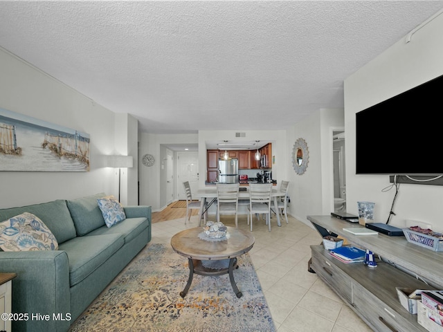 2000 New River Inlet Rd Unit 3513, North Topsail Beach, NC 28460 - living area featuring light tile patterned flooring and a textured ceiling
