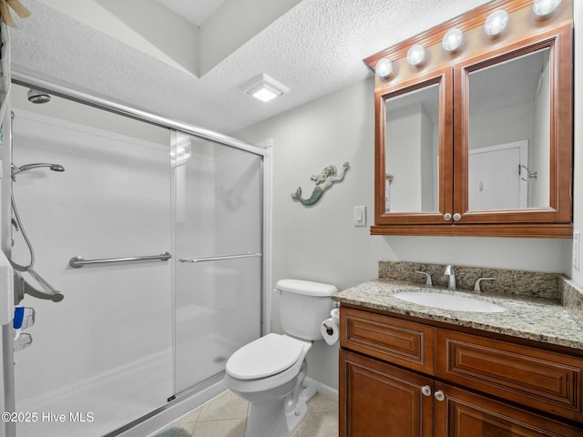 2000 New River Inlet Rd Unit 3513, North Topsail Beach, NC 28460 - bathroom featuring vanity, a stall shower, tile patterned floors, a textured ceiling, and toilet