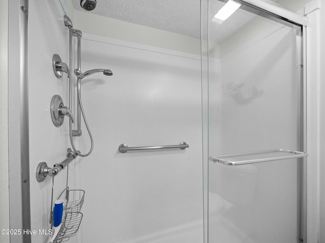 2000 New River Inlet Rd Unit 3513, North Topsail Beach, NC 28460 - full bathroom featuring a stall shower and a textured ceiling