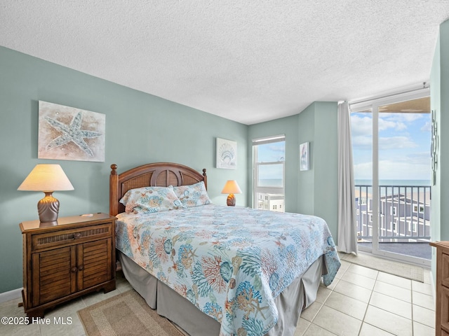 2000 New River Inlet Rd Unit 3513, North Topsail Beach, NC 28460 - tiled bedroom with access to exterior and a textured ceiling