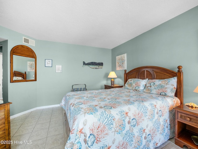 2000 New River Inlet Rd Unit 3513, North Topsail Beach, NC 28460 - bedroom with visible vents, baseboards, light tile patterned floors, and a textured ceiling