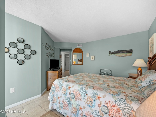 2000 New River Inlet Rd Unit 3513, North Topsail Beach, NC 28460 - bedroom featuring visible vents, tile patterned floors, baseboards, and a textured ceiling