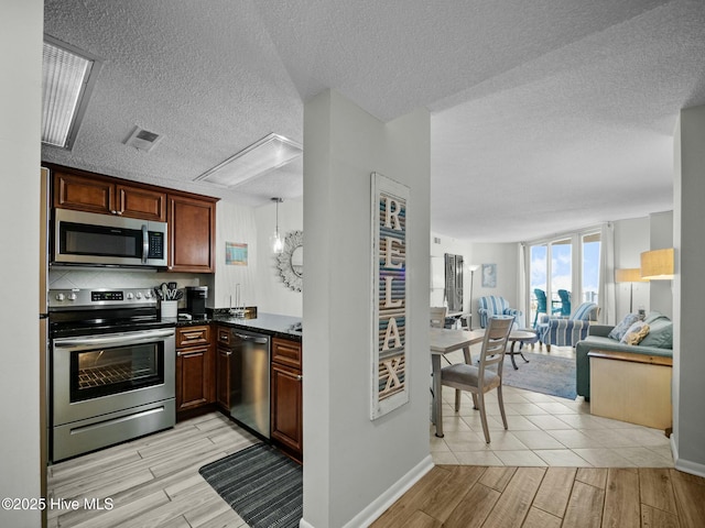 2000 New River Inlet Rd Unit 3513, North Topsail Beach, NC 28460 - kitchen with open floor plan, appliances with stainless steel finishes, wood finish floors, and visible vents
