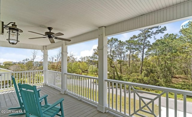 wooden deck with a ceiling fan
