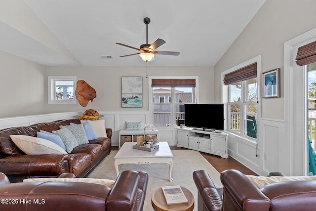 living room featuring a healthy amount of sunlight, visible vents, a ceiling fan, and vaulted ceiling