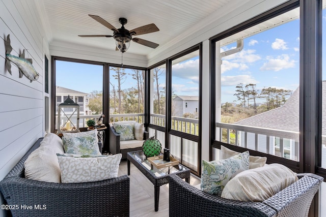 sunroom with ceiling fan and an outdoor hangout area