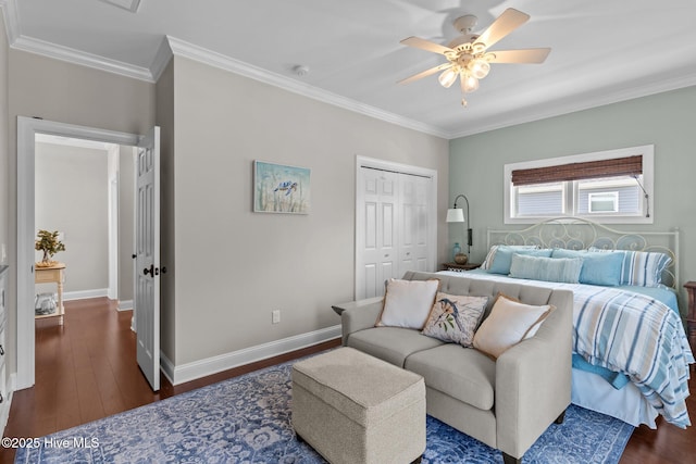 bedroom featuring baseboards, dark wood-style flooring, a closet, and ornamental molding