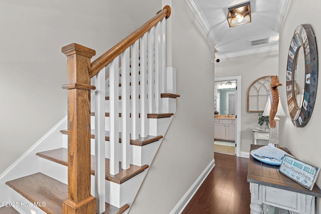 stairs with wood-type flooring, visible vents, baseboards, and crown molding