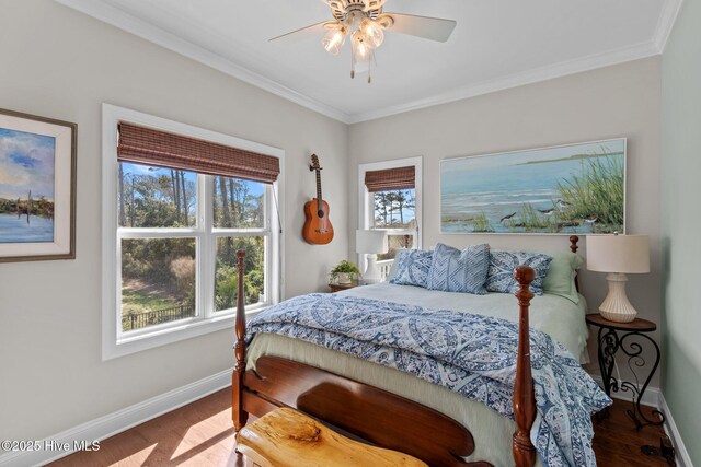 bedroom featuring crown molding, baseboards, and multiple windows
