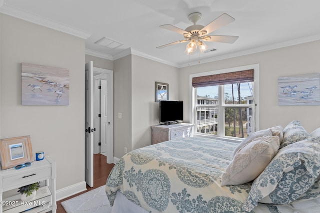 bedroom featuring visible vents, baseboards, ceiling fan, crown molding, and wood finished floors