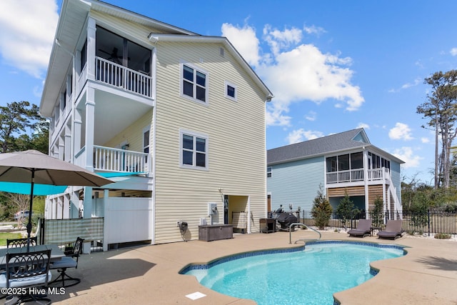 view of pool featuring a fenced in pool, a patio, a sunroom, and fence